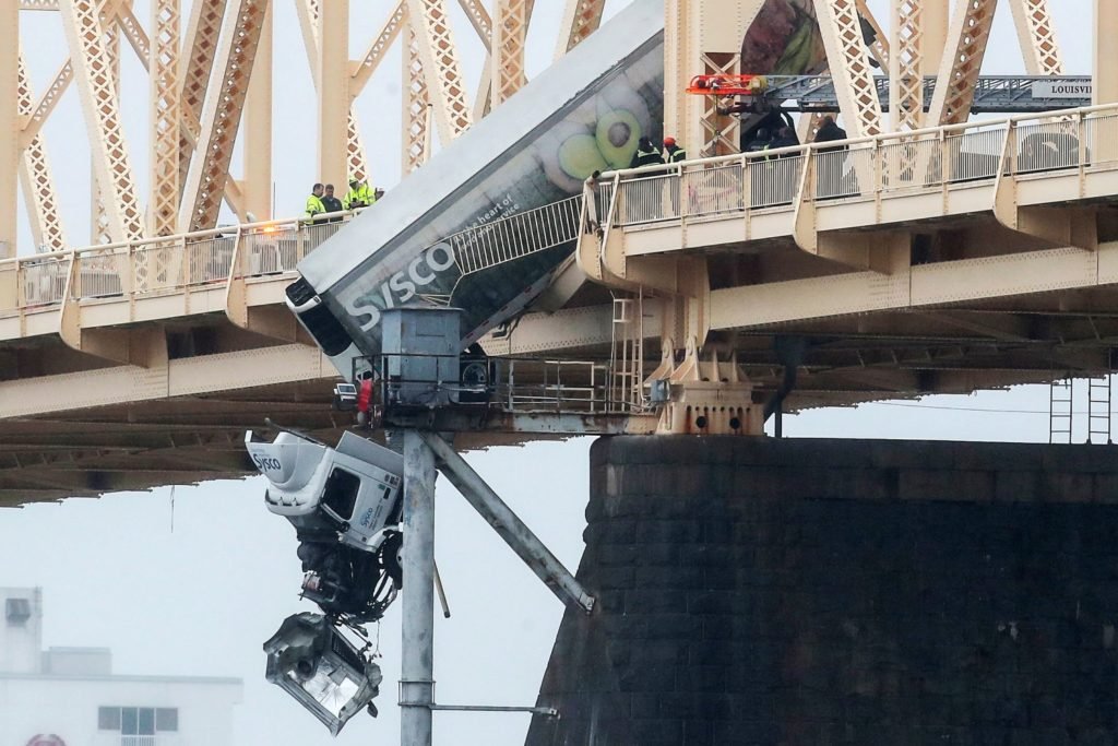 Truck driver pulled to safety after crash leaves vehicle dangling over bridge across Ohio River - NBC News
